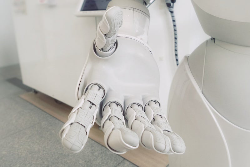 white robot hands reaching out