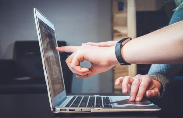 two people working on a laptop