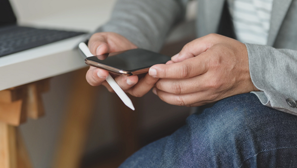 man holding a black smartphone